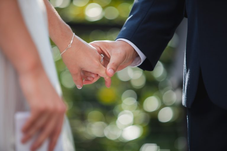 A Virginia bride and groom holding hands at their wedding at Fleetwood Farm Winery in Leesburg.