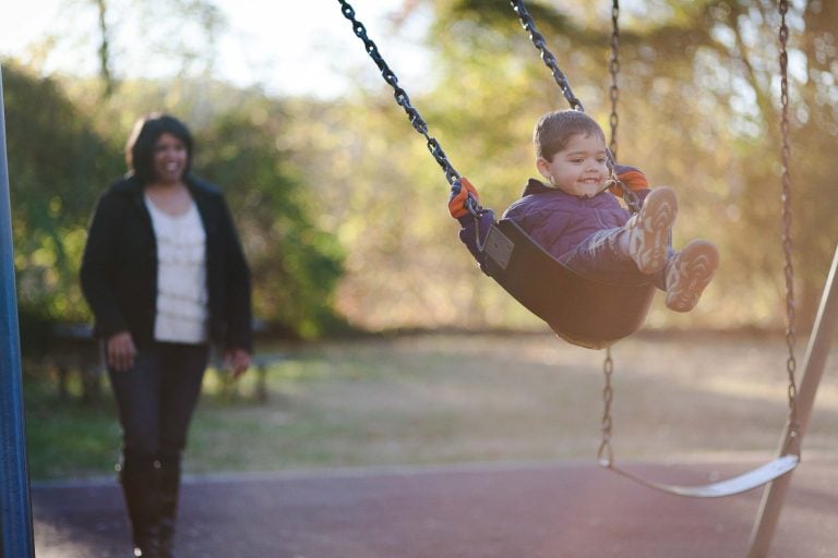 A child is swinging at Glen Echo Park in Maryland.