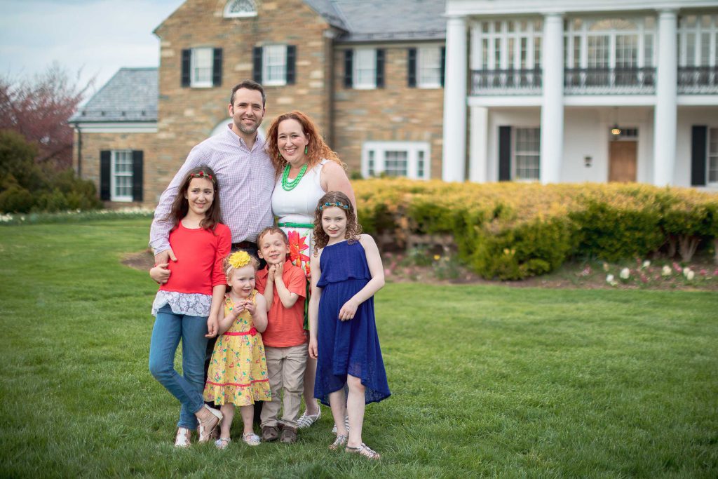 A family posing in front of Glenview Mansion in Maryland.