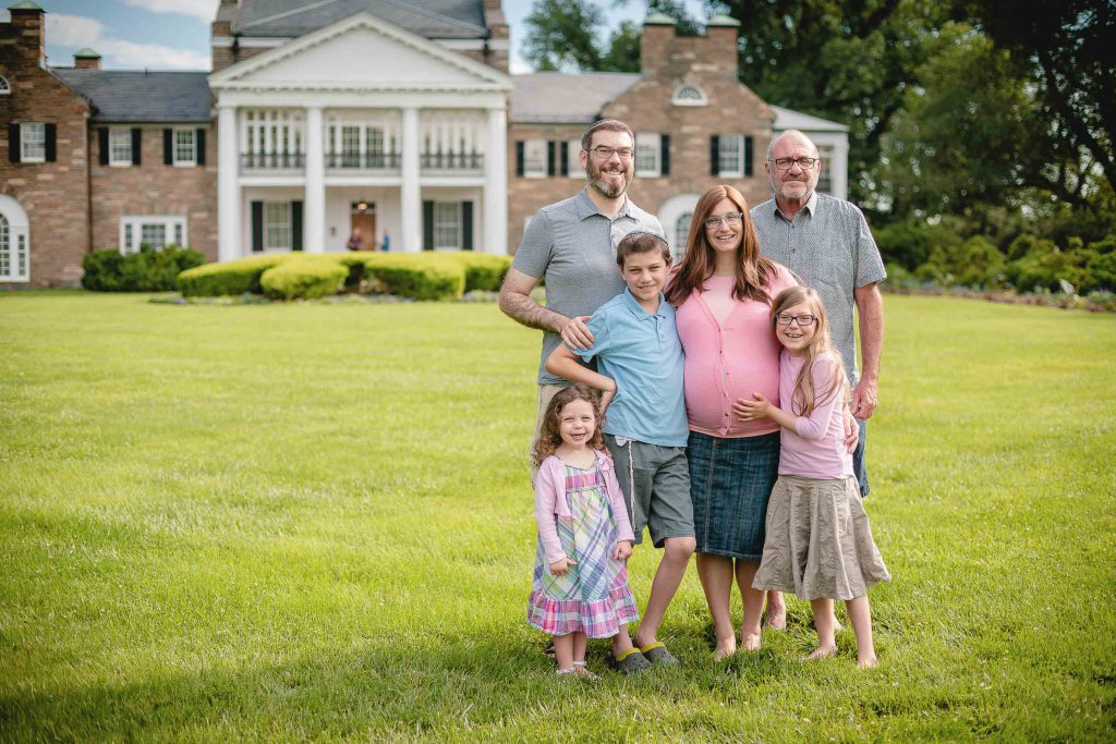 A family posing in front of Glenview Mansion in Rockville, Maryland.