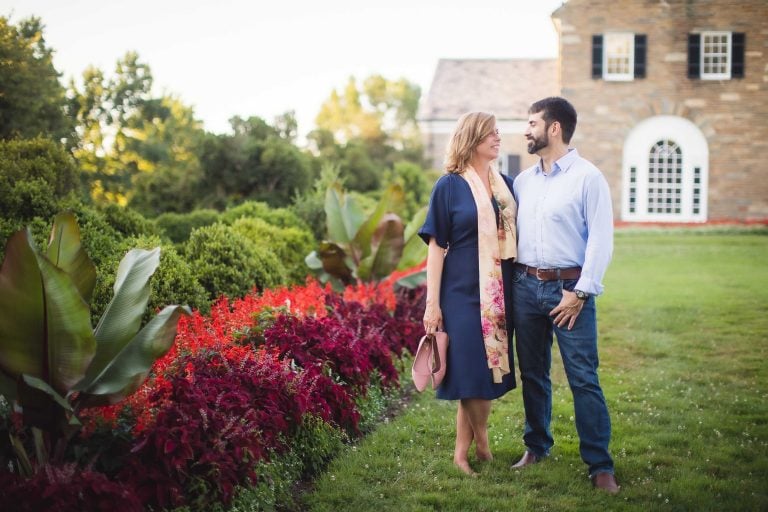 An engaged couple standing in front of Glenview Mansion in Maryland.