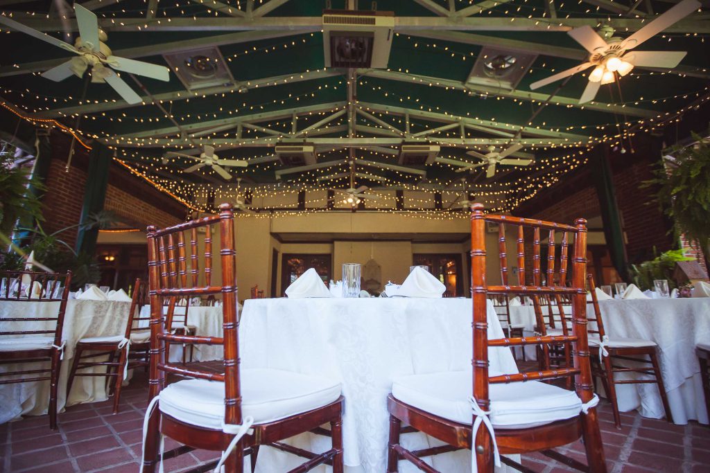 A room with tables and chairs set up for a wedding at Gramercy Mansion in Maryland.