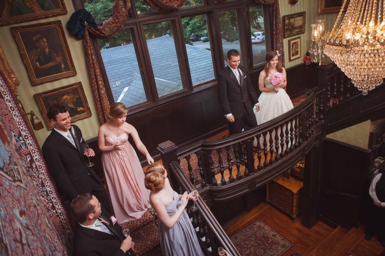 A group of bridesmaids standing on a staircase at Gramercy Mansion in Maryland.