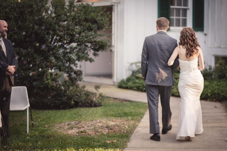 A bride and groom walking down the aisle at Historic Baldwin Hall in Millersville, Maryland.