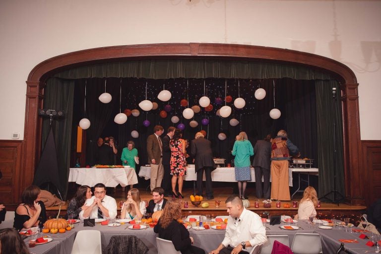 A group of people sitting at tables in Historic Baldwin Hall.