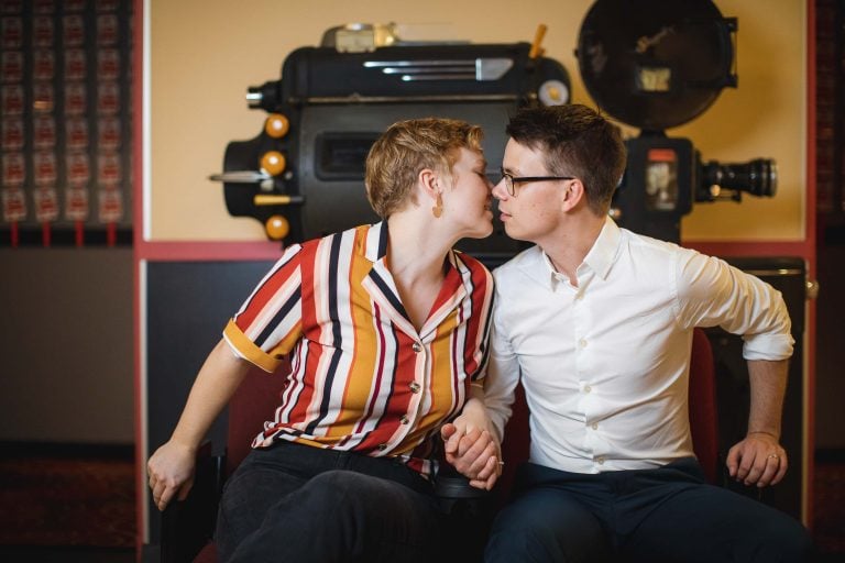 A couple kissing in front of a movie camera at the Old Greenbelt Theatre in Maryland's Greenbelt.