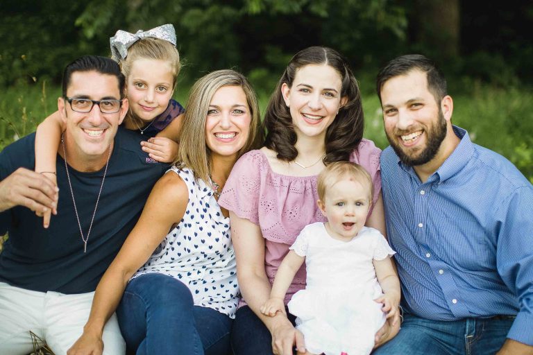 A family is posing for a photo in a field at the Irvine Nature Center in Owings Mills, Maryland.