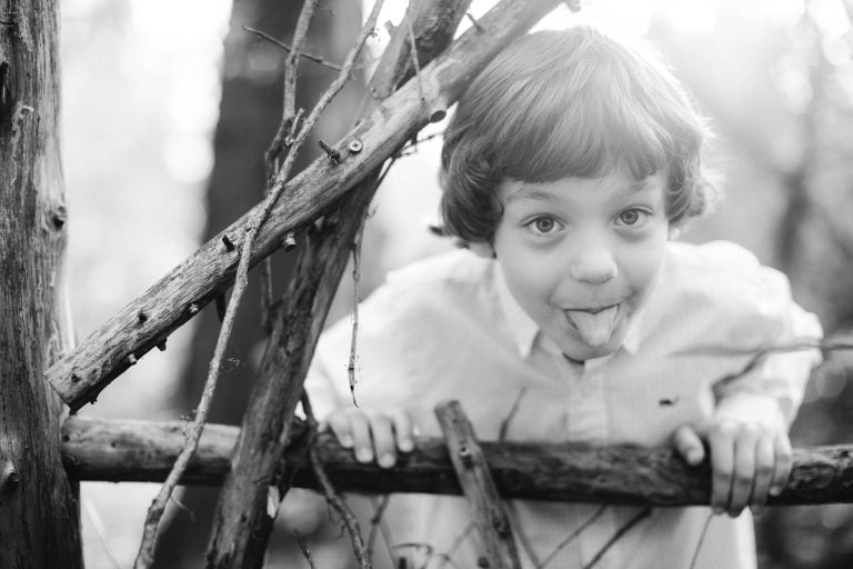 A boy is leaning over a fence at the Irvine Nature Center in Owings Mills, Maryland.