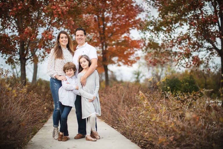 A family is posing for a fall photo at Irvine Nature Center near Owings Mills, Maryland.