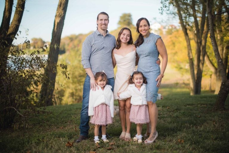 A family is posing for a photo in Jonas and Anne Catharine Green Park.