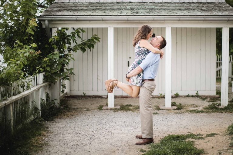 A couple hugging in front of a white shed in Virginia's Alexandria.