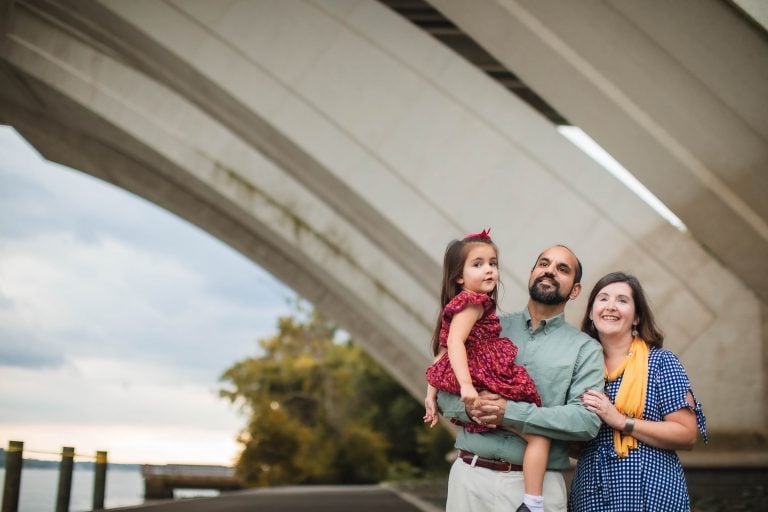 A family is posing under the Jones Point Park bridge in Alexandria, Virginia.