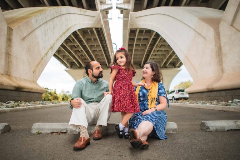 A family sits under a bridge in Jones Point Park, Virginia.