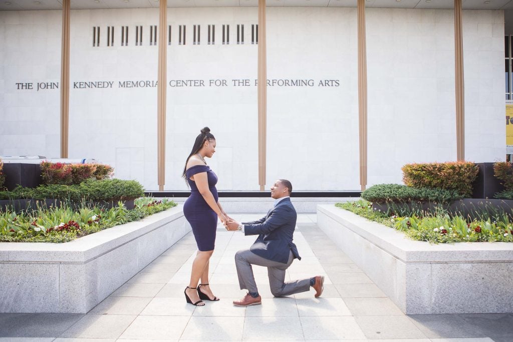 A man proposing to a woman on the Kennedy Center Grounds in Washington DC.