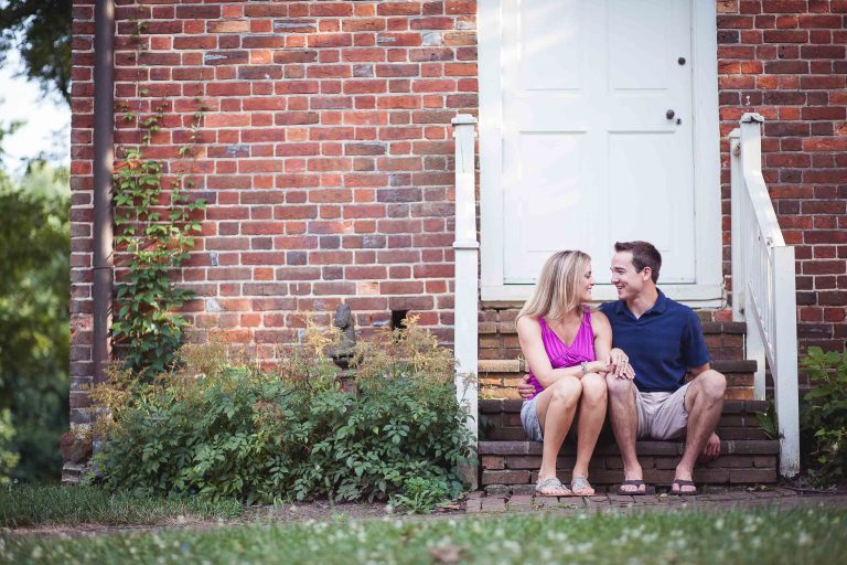 A couple sits on the steps of Glenn Dale, Maryland's Marietta House.