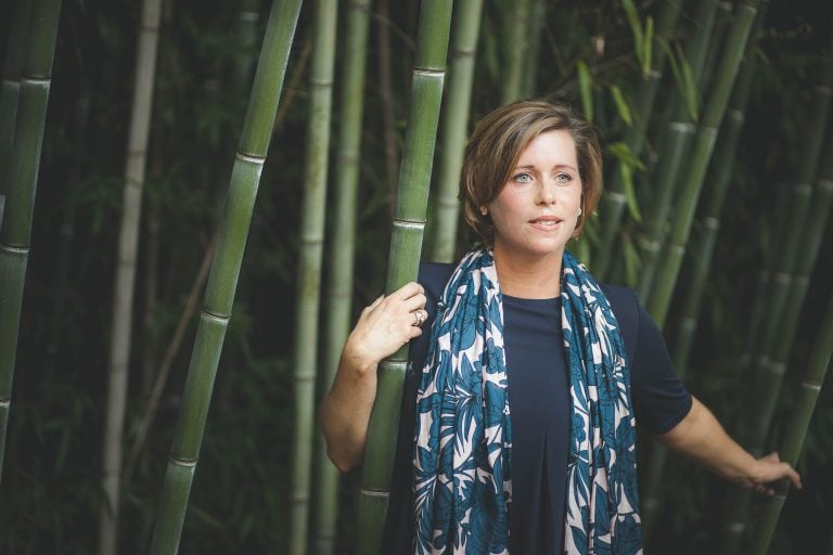 A woman posing in front of bamboo trees at Glenn Dale in Maryland.