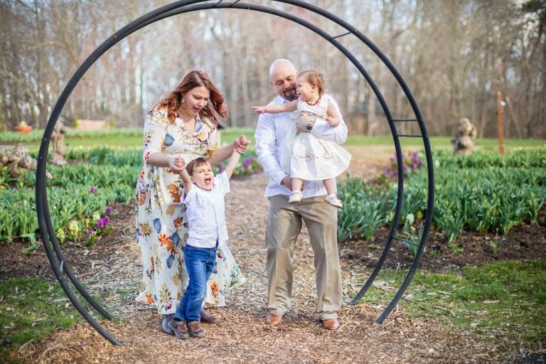 A family is posing for a photo at Meadowlark Botanical Gardens in Vienna, Virginia.