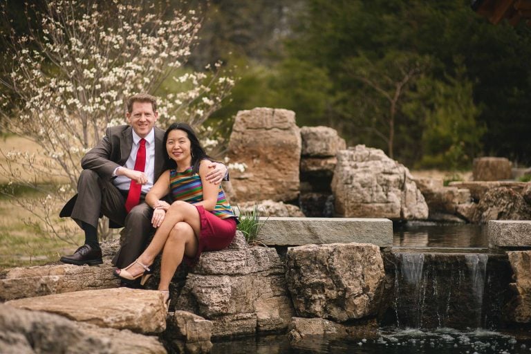 A couple sitting on rocks at Meadowlark Botanical Gardens in Vienna, Virginia.