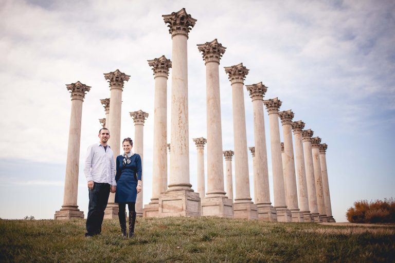 A couple standing in front of columns at the National Arboretum.