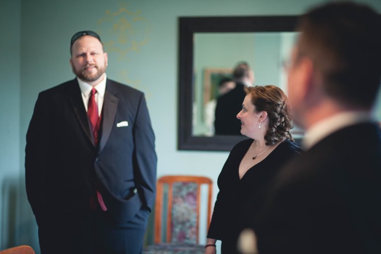 A man in a tuxedo and a woman in a red dress at the Manor at Silo Falls in Brookeville, Maryland.