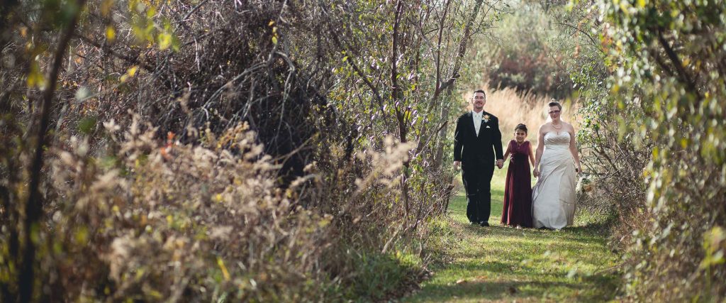 A bride and groom walking down a path in Brookeville, Maryland.