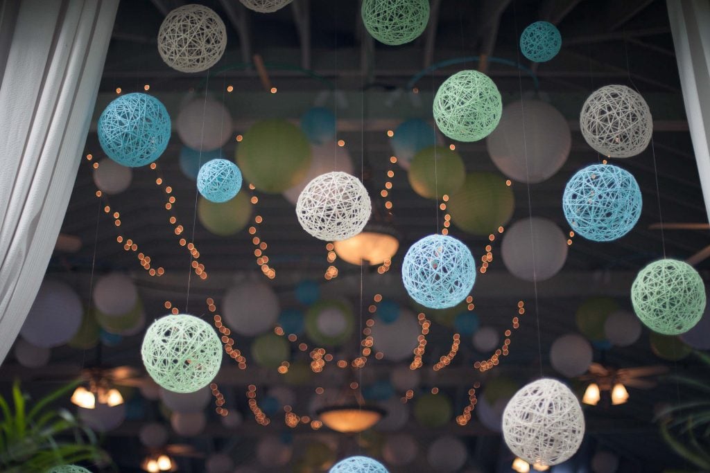 A bunch of green paper mache balls hanging from the ceiling at Vandiver Inn.