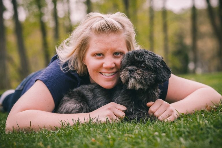 A woman laying on the grass with her Wheaton Regional Park.