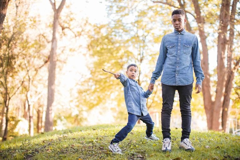 A man and his son are holding hands in Wheaton Regional Park.