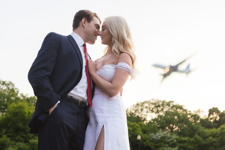 A bride and groom kissing in front of the George Mason Memorial in Washington DC.