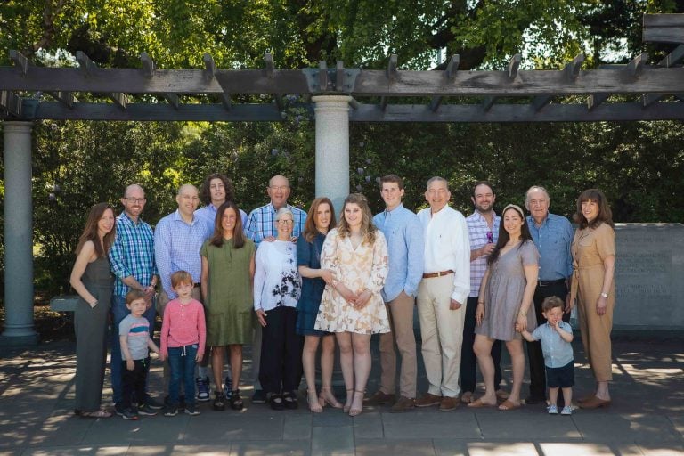 A family posing for a photo in front of the George Mason Memorial in Washington DC.