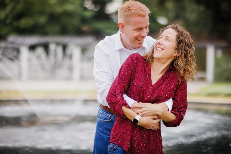 A couple embracing in front of the George Mason Memorial in Washington DC.