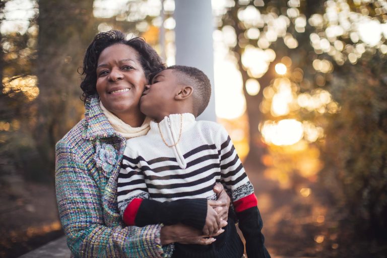 An older woman kisses her son at the George Mason Memorial in Washington DC.