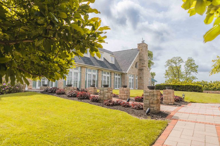 A large house with a large lawn and trees located in Hunt Valley, Maryland.