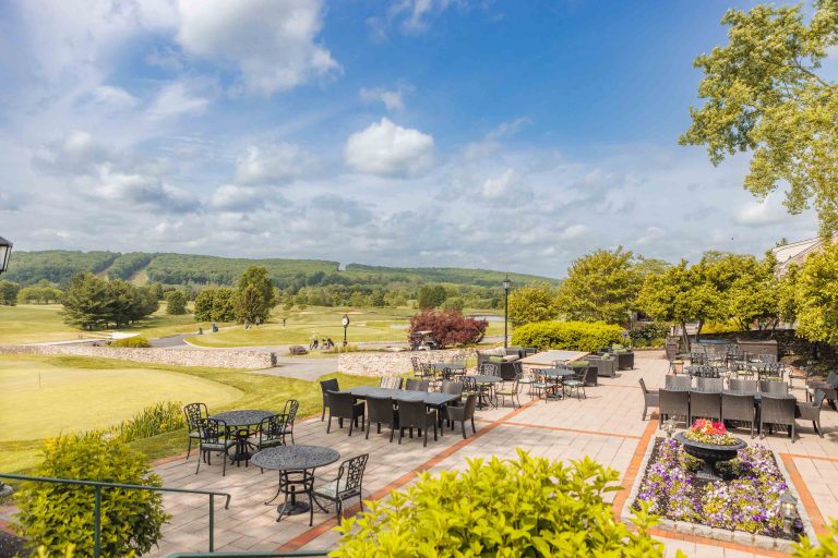 A view of Hayfields Country Club golf course with tables and chairs.