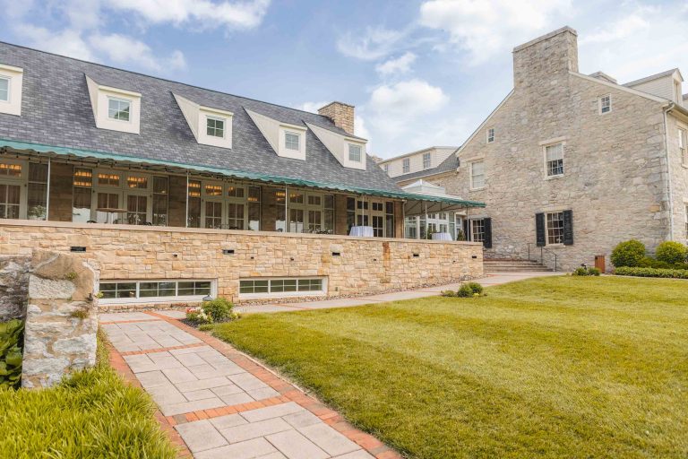 A stone house with a lawn in front of it located in Maryland.