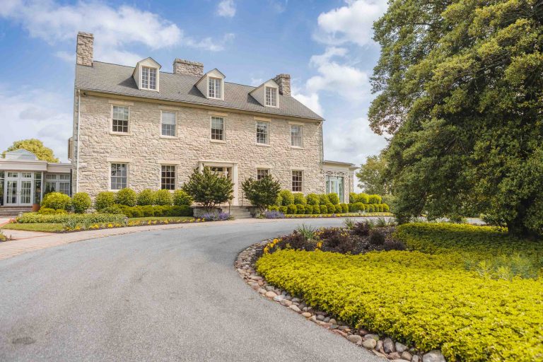 A large stone house in Hunt Valley, Maryland with a paved driveway.