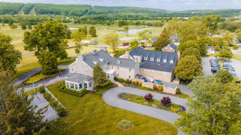 An aerial view of a large house surrounded by trees in Hunt Valley.