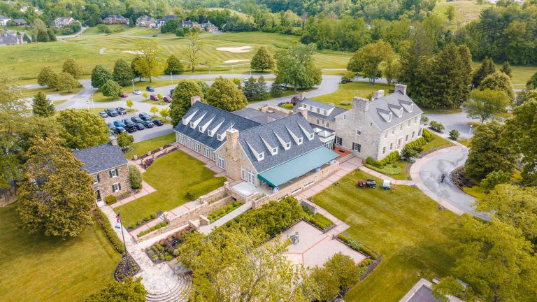 An aerial view of a large house surrounded by trees in Maryland.