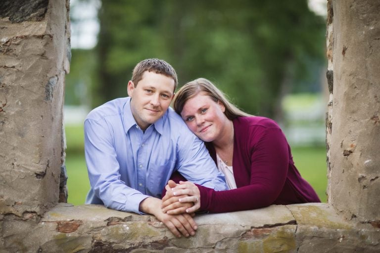 A man and woman leaning against a stone wall in Bel Air, Maryland.