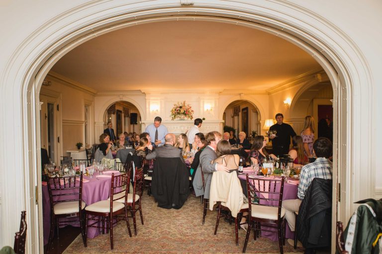 A group of people sitting at a table in the Liriodendron Mansion in Maryland.