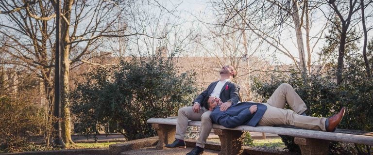 Two men laying on a bench in Meridian Hill Park, Washington DC.