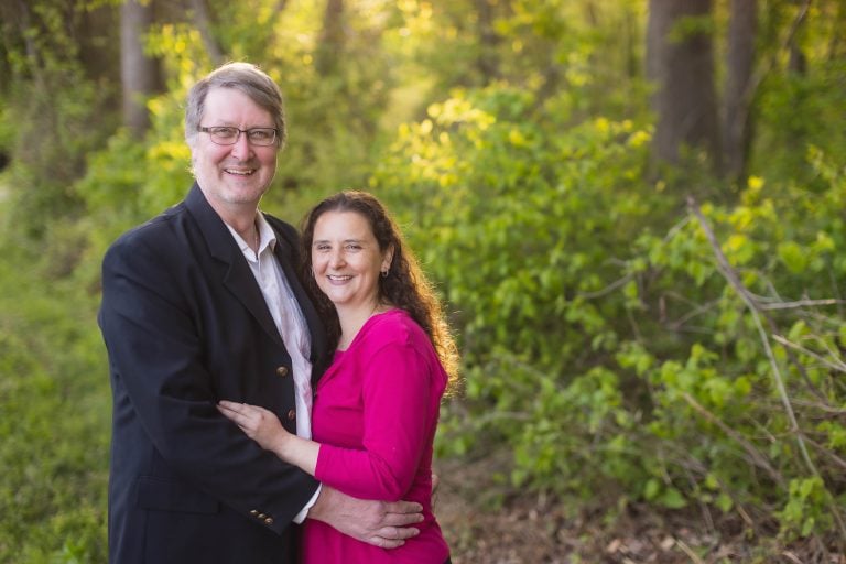 A man and woman are posing for a photo in the Maryland woods near Bowie at Mill Branch Pond.