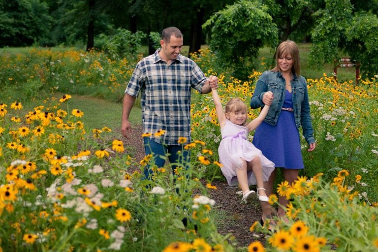 A family walks through Laurel, Maryland's field of flowers with their daughter.