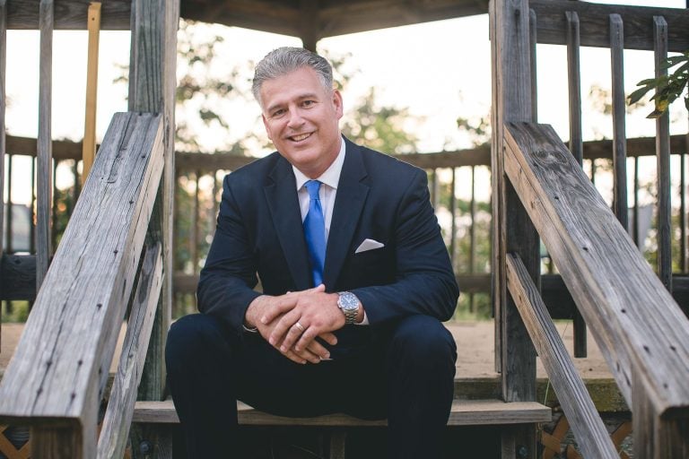 A man in a suit sitting at Terrapin Nature Park.