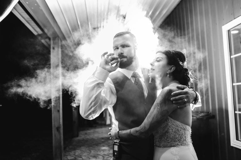 A bride and groom with smoke coming out of their mouths at Two Lions Vineyard in Upper Marlboro, Maryland.