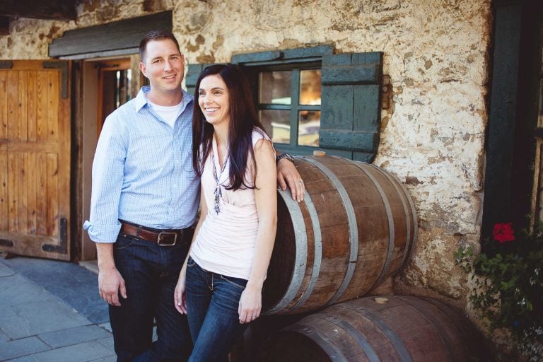 A couple posing in front of wine barrels at Boordy Vineyards in Maryland.