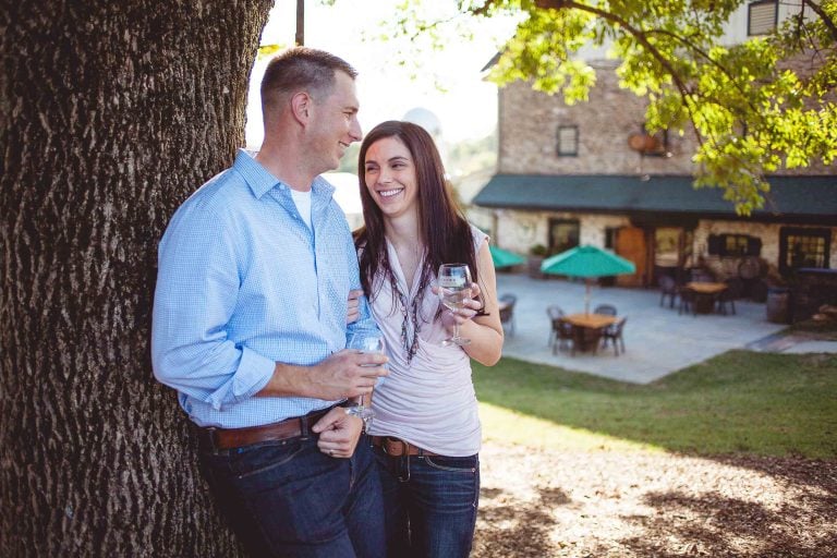 A couple holding wine glasses at Boordy Vineyards in Maryland.