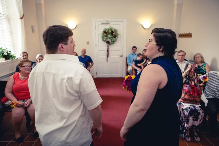 A man and woman standing in front of a room full of people in Circuit Court for Anne Arundel County, Maryland, Annapolis.