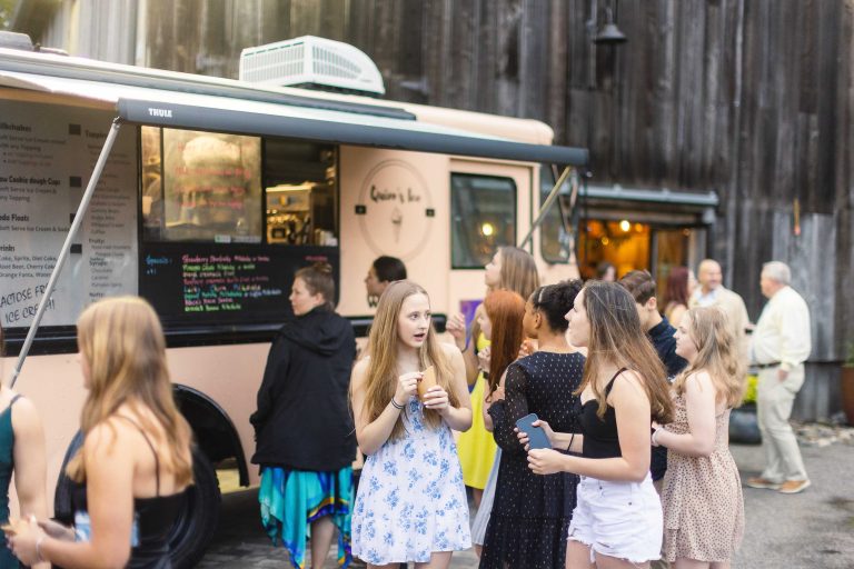 A group of people standing in front of a food truck in Annapolis, Maryland.