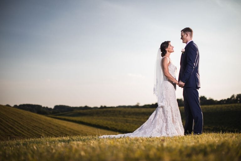 A bride and groom standing in a field at Linganore Winecellars, Maryland.